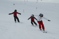 Skilehrer mit Kindern